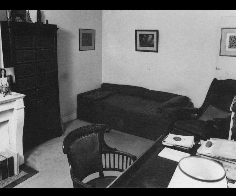 Room with desk, divan, chest, photos