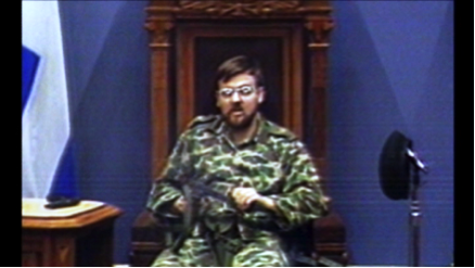 1: Denis Lortie, armed with a submachine gun, sits in the President’s chair in the Blue Chamber at the Quebec National Assembly.